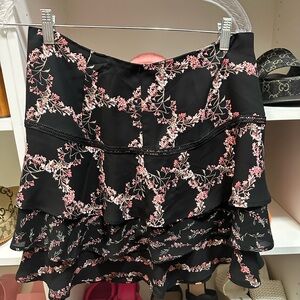 WHBM black flouncy mini skirt with floral pattern size 8
